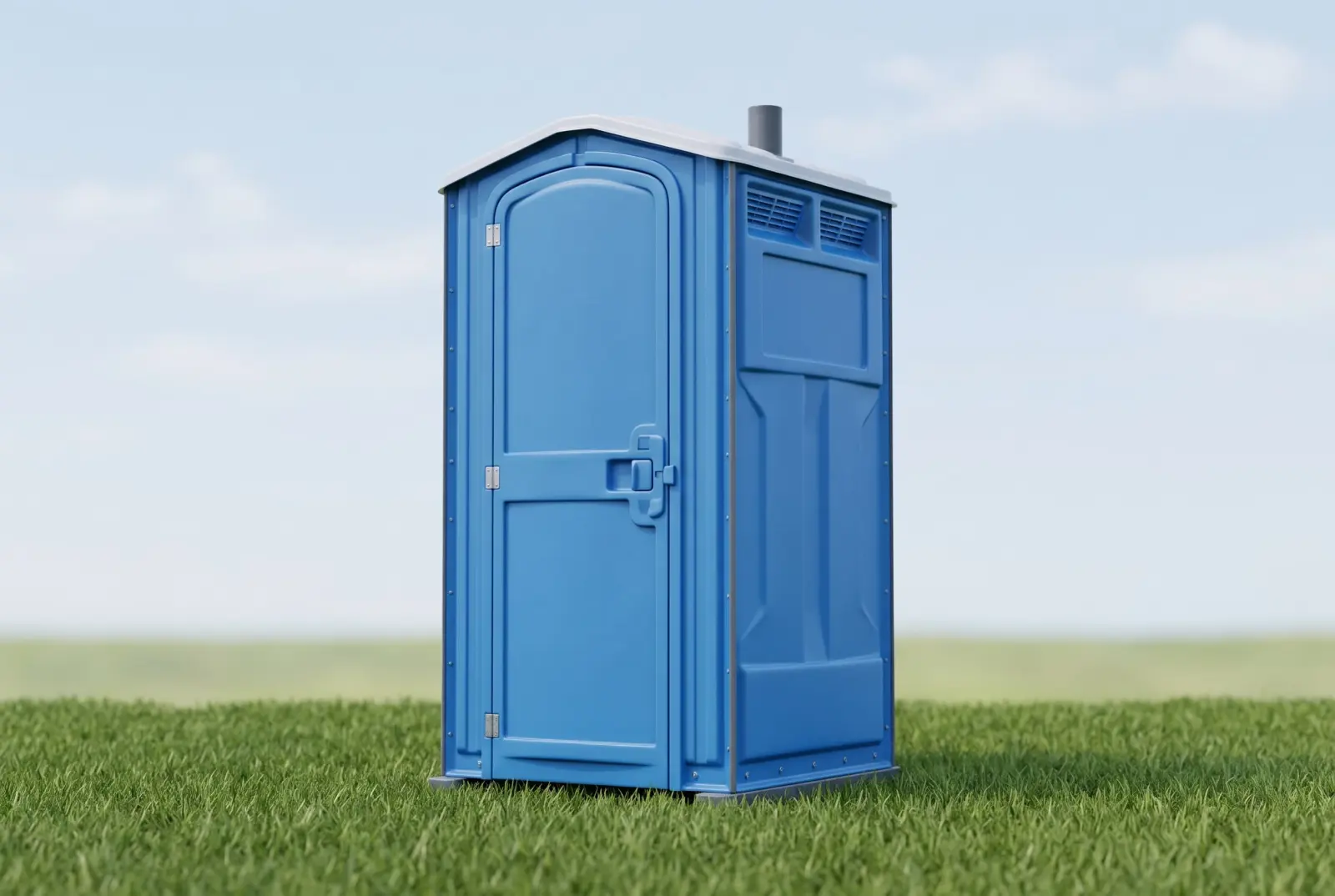 Standard portable toilet outdoors on grass